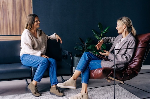 Two Modern Stylish Women Are Sitting In The Office