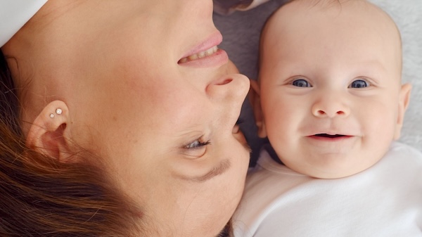 Happy Newborn Baby With His Mother
